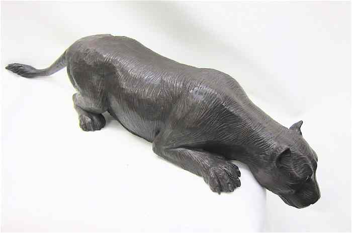 Appraisal: BRONZE WILDLIFE SCULPTURE of a tiger crouching and peering about