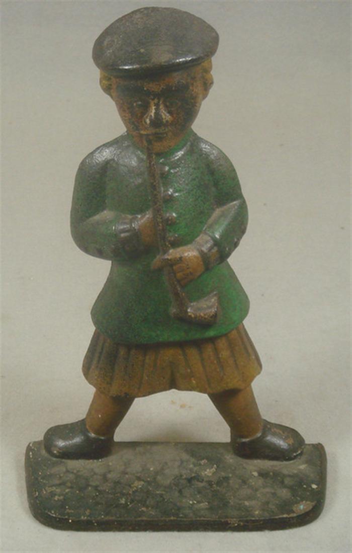 Appraisal: Cast iron doorstop large man in quilt with pipe in