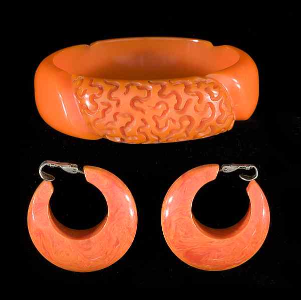 Appraisal: Carved Orange Bakelite Bangle and Earrings A carved Bakelite bangle