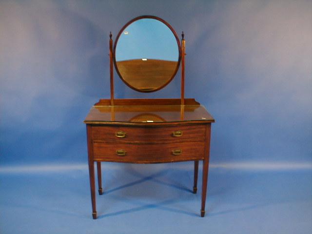 Appraisal: An early thC mahogany serpentine dressing table with oval mirror