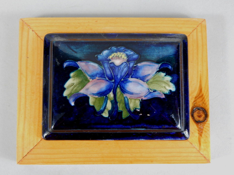 Appraisal: A Moorcroft rectangular pot lid decorated with a flower on