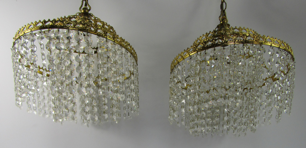 Appraisal: A pair of brass framed circular two tier chandeliers with