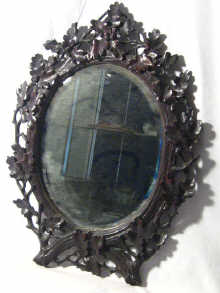 Appraisal: A pair of oak Black Forest mirrors well carved with