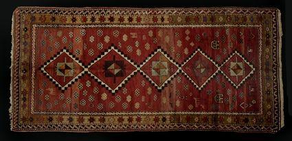 Appraisal: CAUCASIAN LONG RUG The wine red field with conjoined stepped