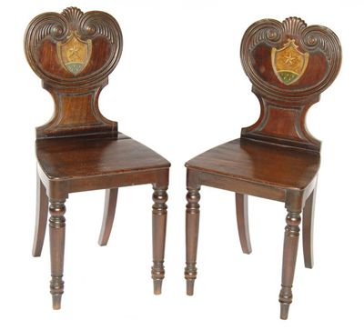 Appraisal: A pair of late Regency mahogany hall chairs the carved