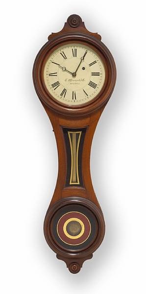 Appraisal: An American Victorian walnut and eglomis figure eight wall clock