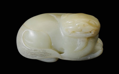 Appraisal: Carved Jade Buddhist Lion Chinese th or th century greenish-yellow