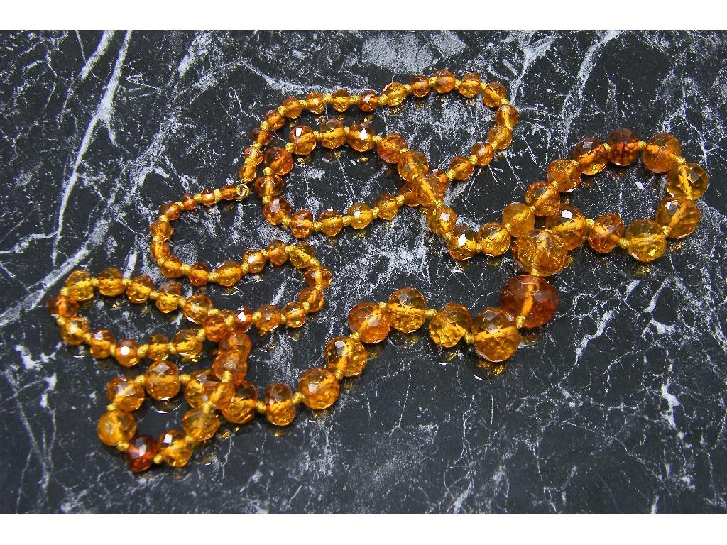 Appraisal: Golden red facet cut graduated amber bead necklace long