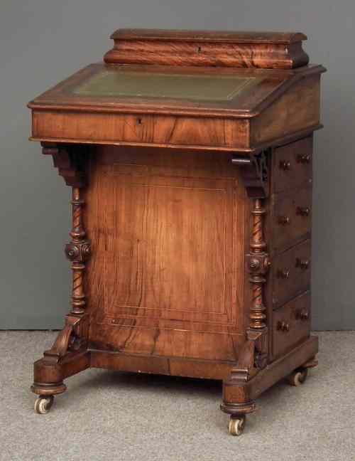 Appraisal: A Victorian figured walnut Davenport the superstructure with stationery compartment