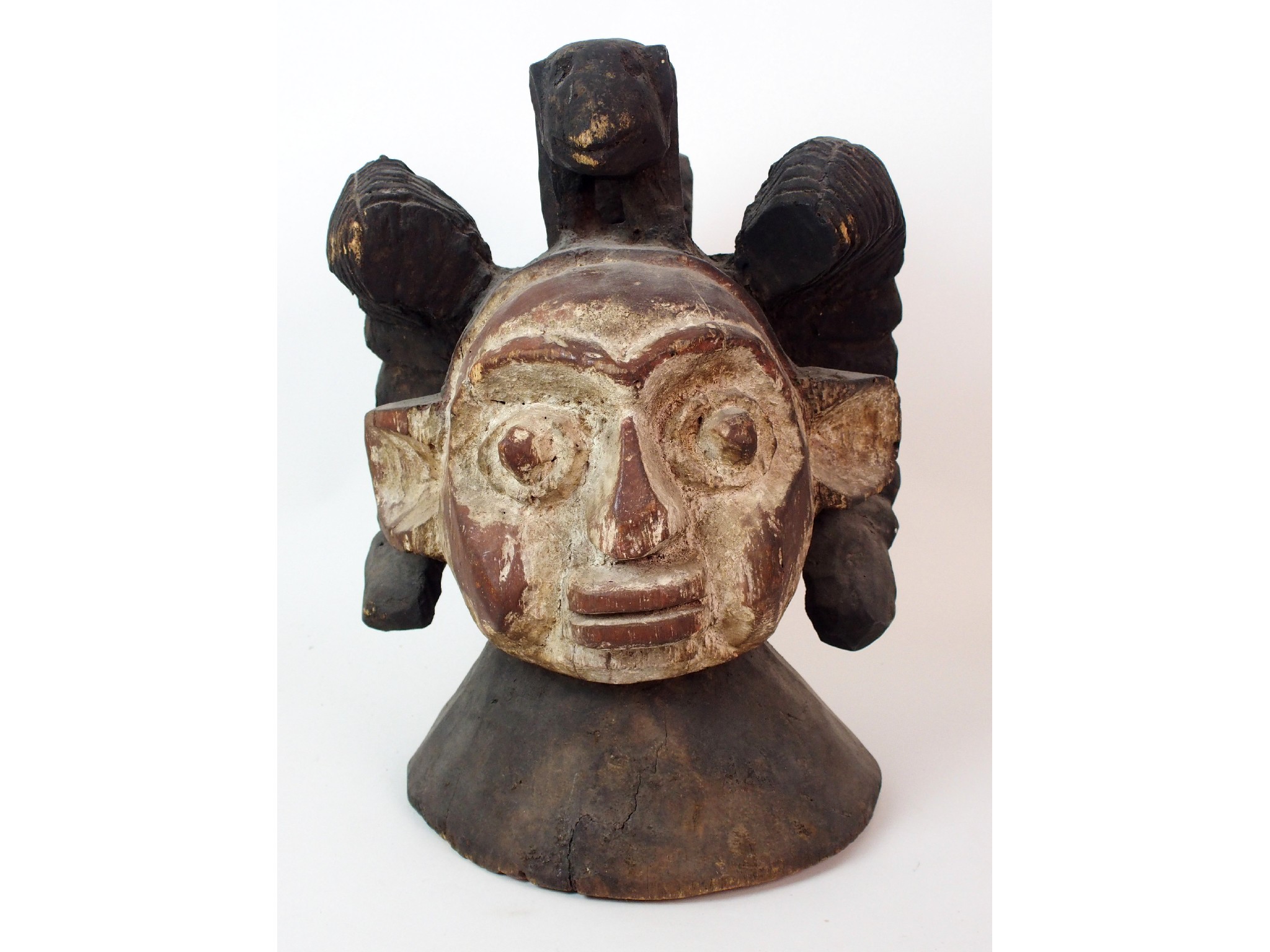 Appraisal: An African carved and painted wood maskwith animal finial and