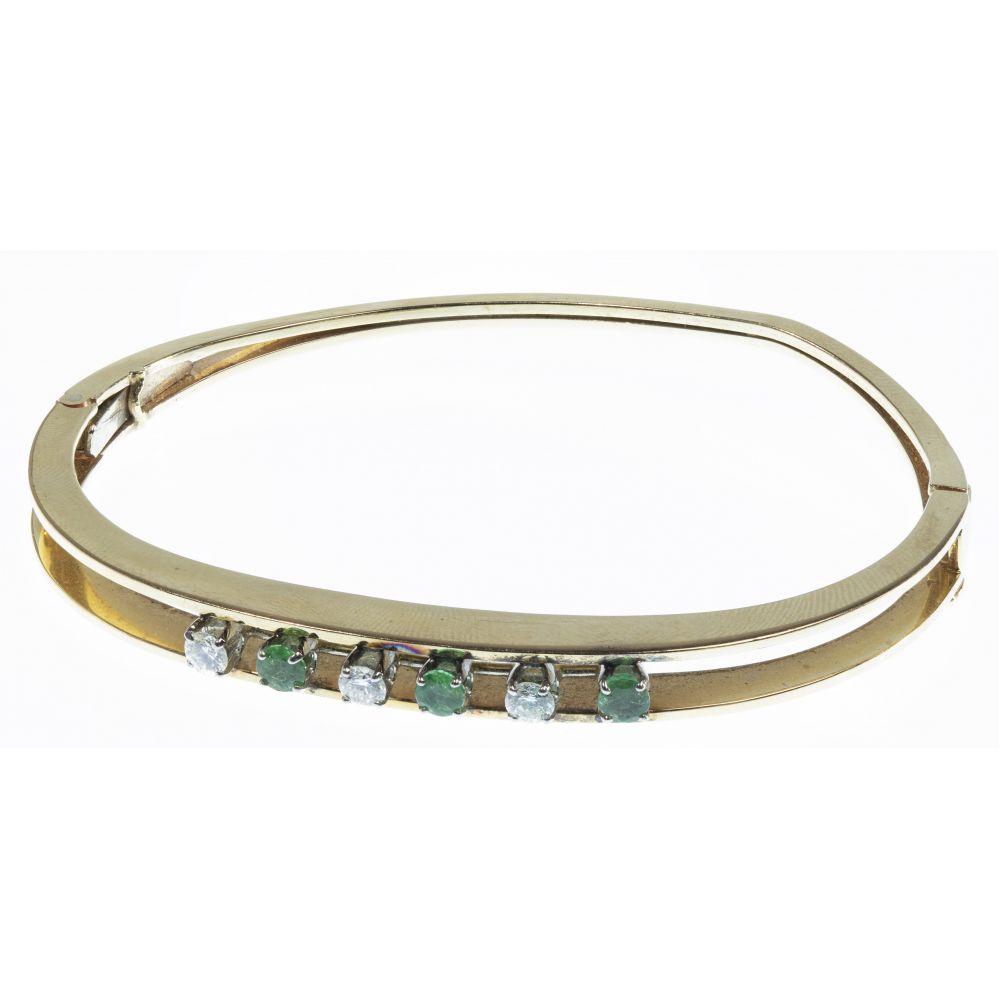 Appraisal: K YELLOW GOLD EMERALD AND DIAMOND HINGED BANGLE BRACELETHaving alternating