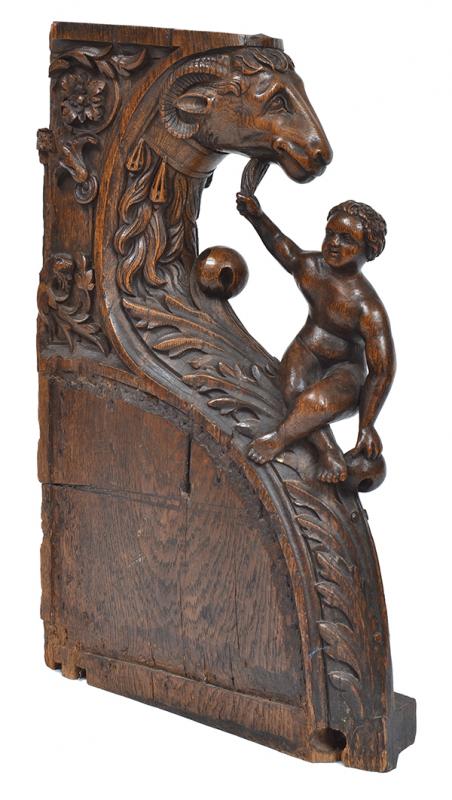 Appraisal: A CONTINENTAL FIGURAL OAK CORBEL carved with a putto beneath