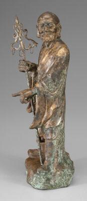 Appraisal: Chinese bronze lohan standing with head turned holding staff in