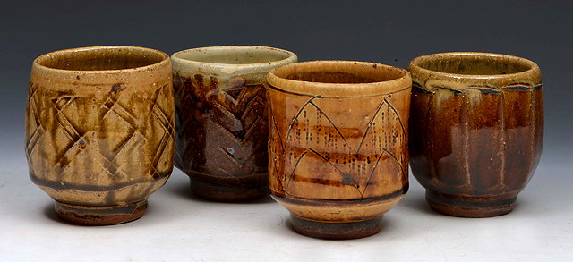 Appraisal: Mike Dodd British b Four unomi tea bowls ash glazes