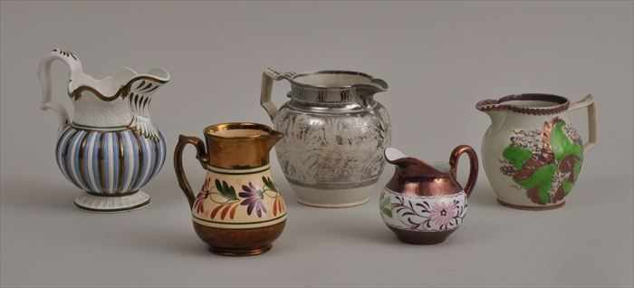 Appraisal: FIVE STAFFORDSHIRE LUSTER-DECORATED MILK JUGS Each baluster or ovoid body