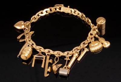 Appraisal: An ct yellow gold charm bracelet the curb link bracelet