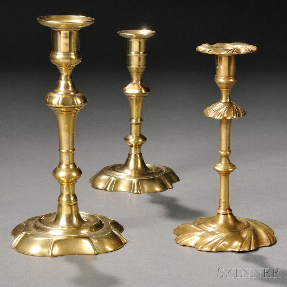 Appraisal: Three Brass Candlesticks two th century English sticks with similarly