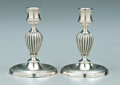 Appraisal: Pair Continental silver candlesticks round with floral borders melon central