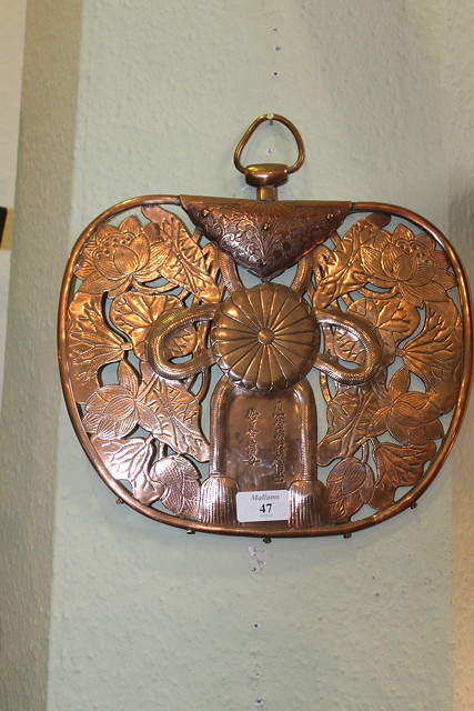 Appraisal: A JAPANESE COPPER RELIEF WALL PLAQUE with inscription and lotus