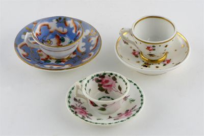 Appraisal: Three miniature English porcelain teacups and saucers variously painted with