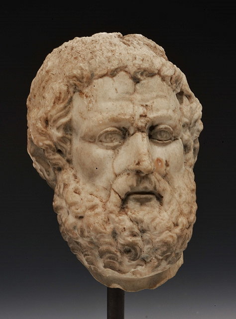 Appraisal: A CARVED WHITE MARBLE HEAD of a hirsute male subject