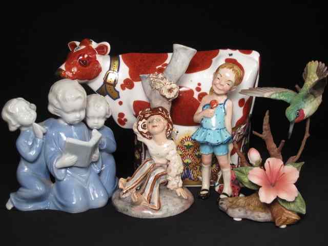 Appraisal: Five porcelain figurines boy under a tree Girl with lollipop