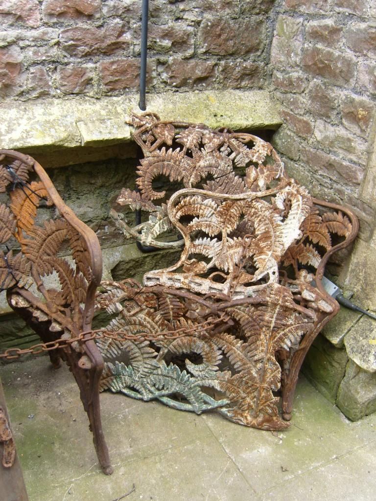 Appraisal: Two similar th century cast iron garden benches with fern