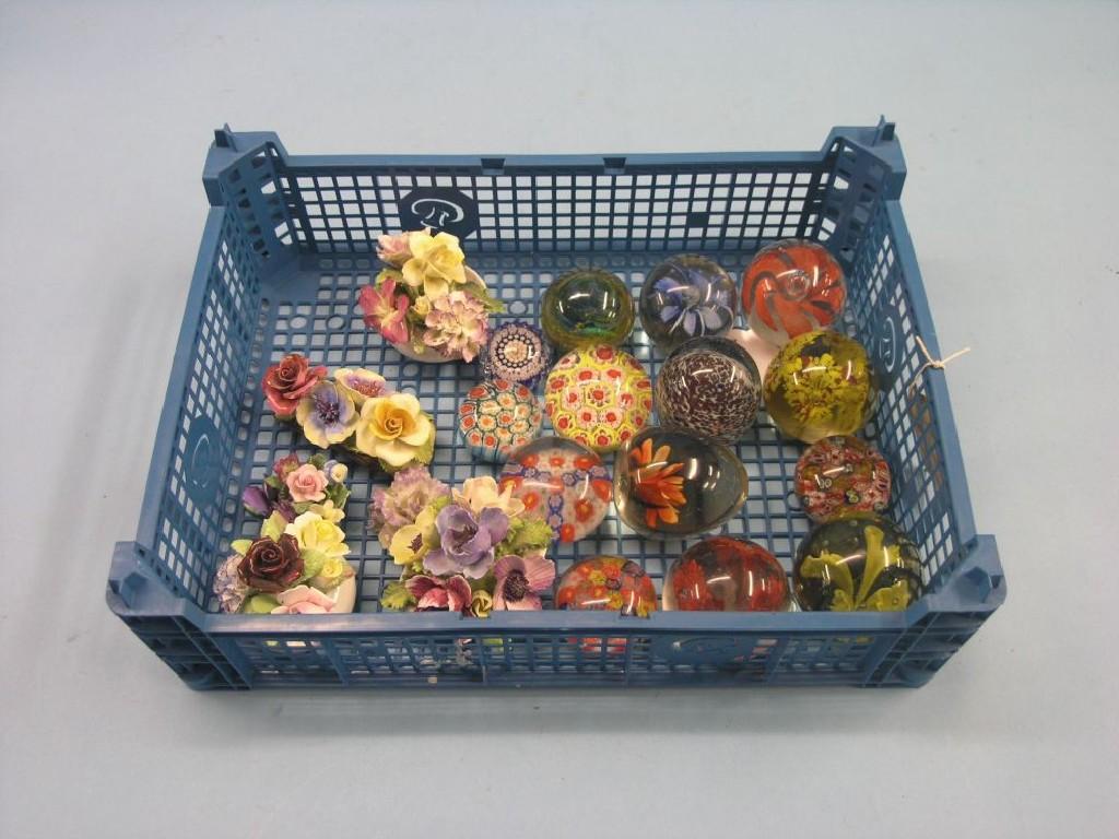 Appraisal: Fourteen various coloured glass paperweights and six ceramic flower ornaments