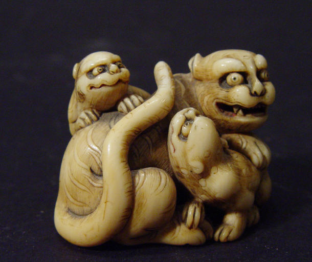 Appraisal: Oriental ivory Netsuke well carved as a tiger and young