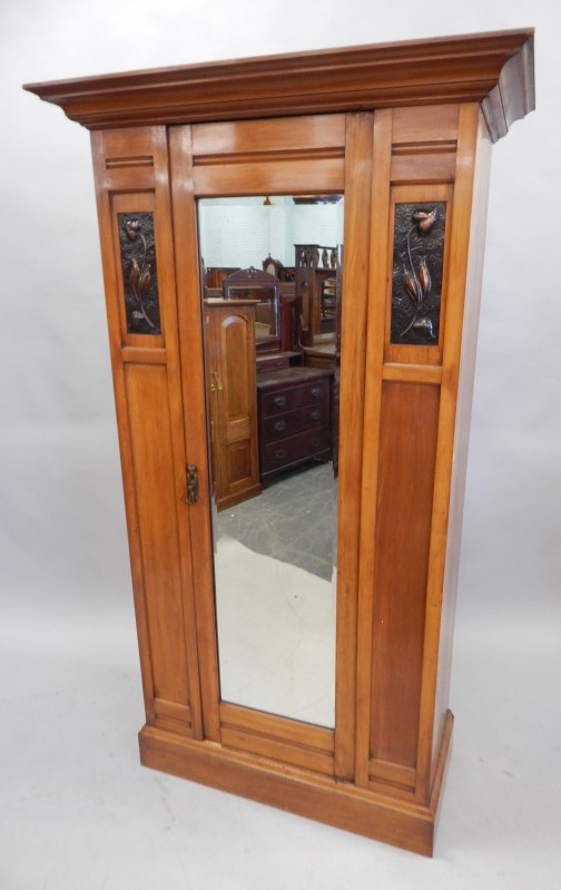 Appraisal: A late Victorian pale walnut wardrobe the top with a