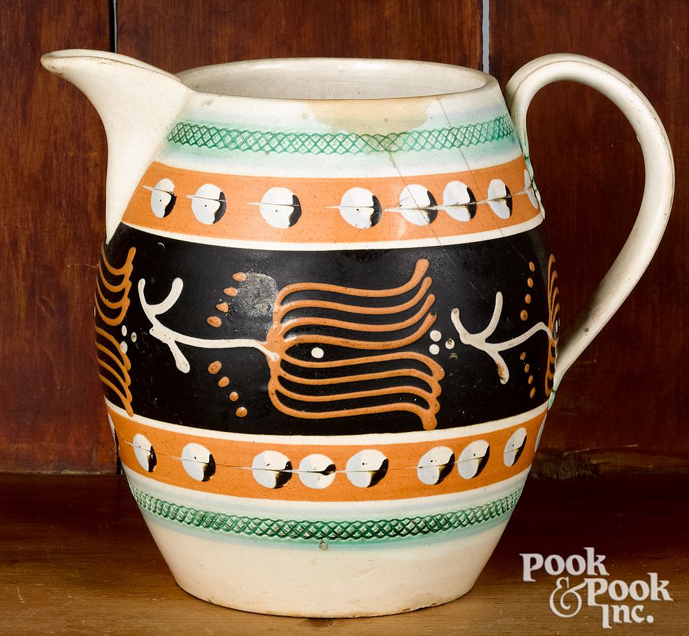 Appraisal: Mocha pitcher with cat's-eye and tulip decoration Mocha pitcher with