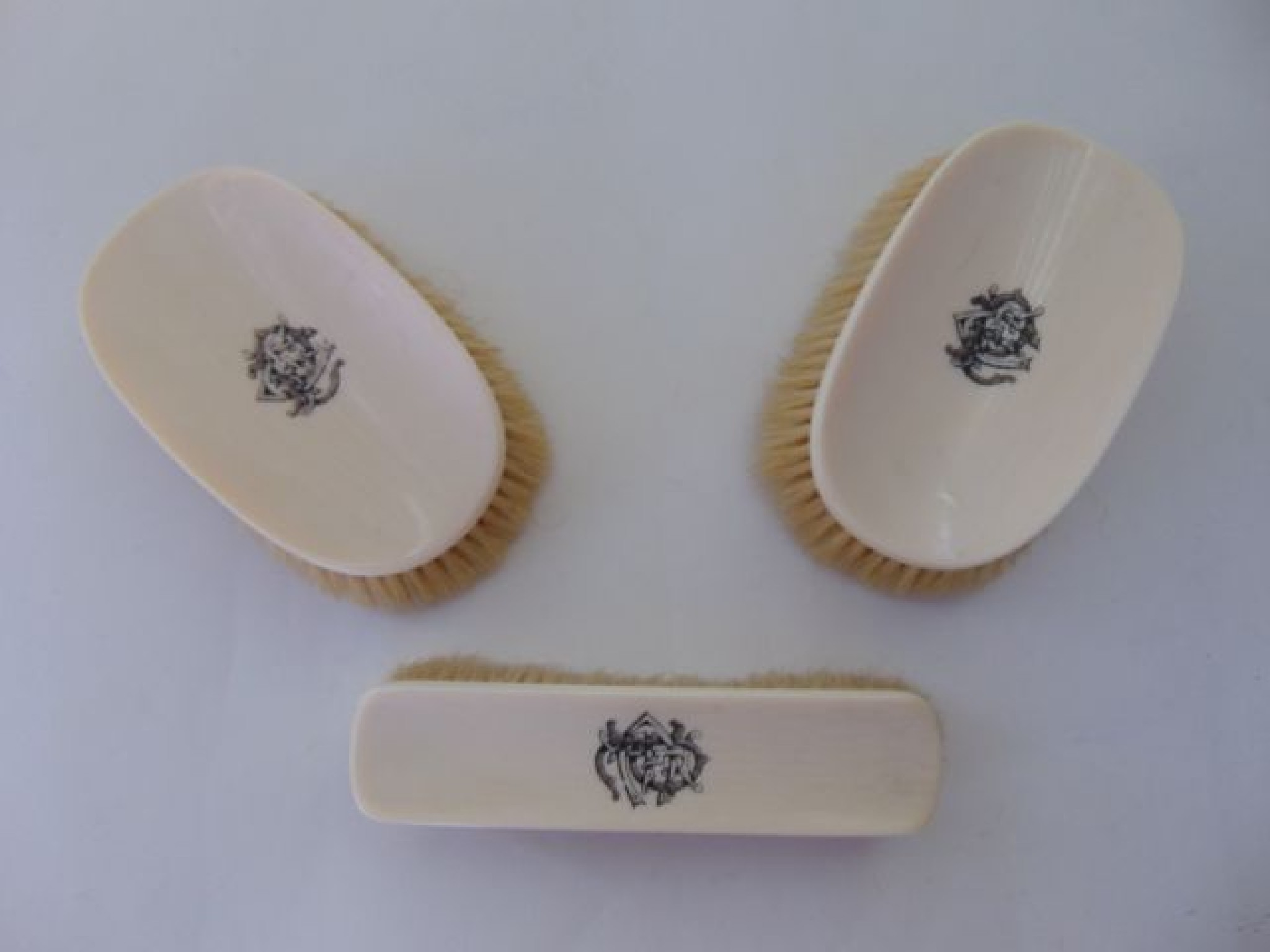 Appraisal: A set of three Victorian ivory backed brushes all monogrammed