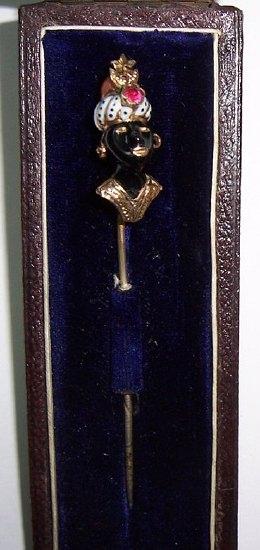 Appraisal: A stick pin with gem set Nubian bust with coral