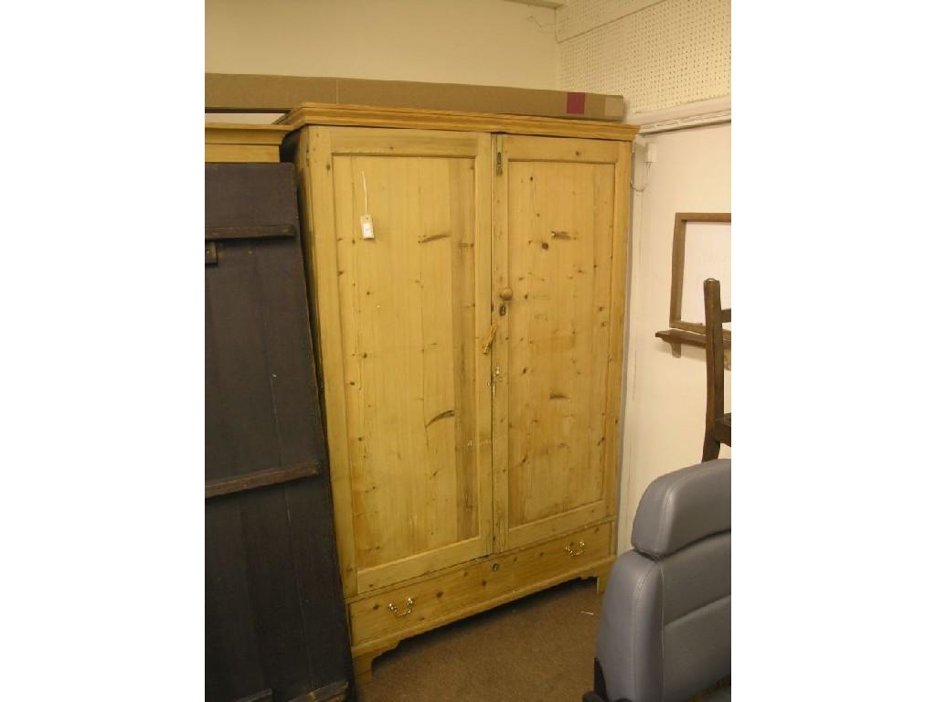 Appraisal: A Victorian pine wardrobe enclosed by a pair of panelled