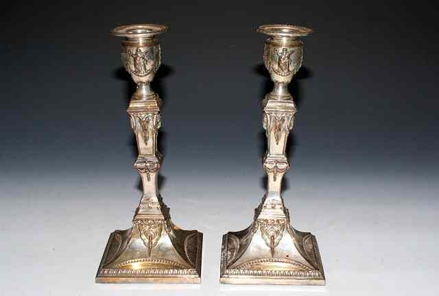 Appraisal: A PAIR OF SILVER NEO-CLASSICAL CANDLESTICKS on square tapering bases