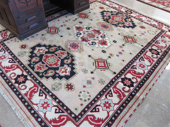 Appraisal: HAND KNOTTED ORIENTAL CARPET Indo-Persian colorful three geometric medallion design