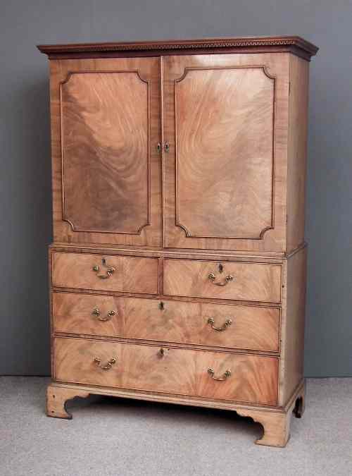 Appraisal: A George III gentleman's mahogany wardrobe the upper part with