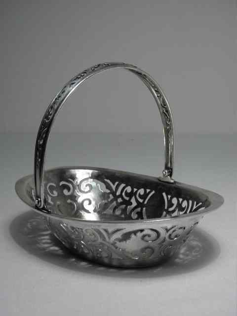 Appraisal: A Russian pierced zolotnik silver handled basket Personalized on side