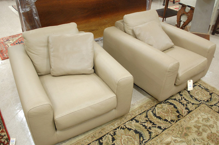 Appraisal: A PAIR OF CONTEMPORARY SWIVEL LEATHER ROCKING ARMCHAIRS made in