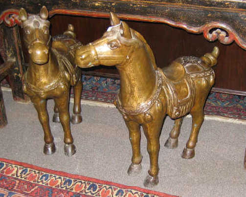 Appraisal: PAIR OF TANG STYLE BRONZE HORSE FIGURES Standing saddled in