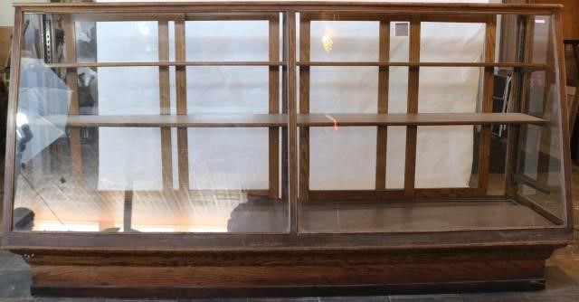 Appraisal: CA LARGE COUNTRY STORE STANDING OAK DISPLAYCASE SLANTED GLASS FRONT