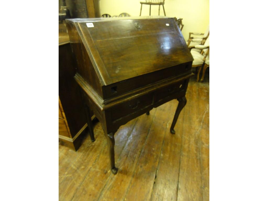 Appraisal: An antique oak bureau the fall front enclosing a fitted