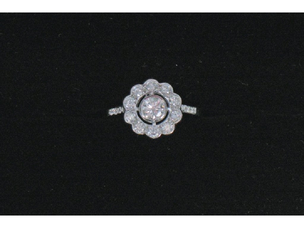 Appraisal: A MODERN DIAMOND CLUSTER RING the central round brilliant-cut diamond