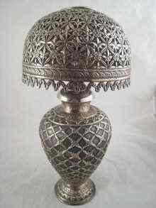 Appraisal: A silver table lamp and shade the body deeply embossed