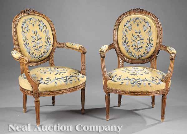 Appraisal: A Pair of Louis XVI-Style Carved Fauteuils with blue and