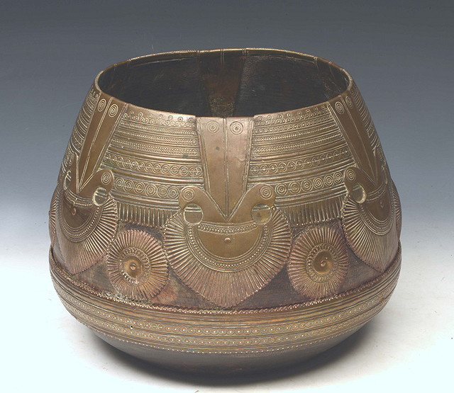 Appraisal: A SOUTH EAST ASIAN OVOID WOODEN BOWL with stylised peacock