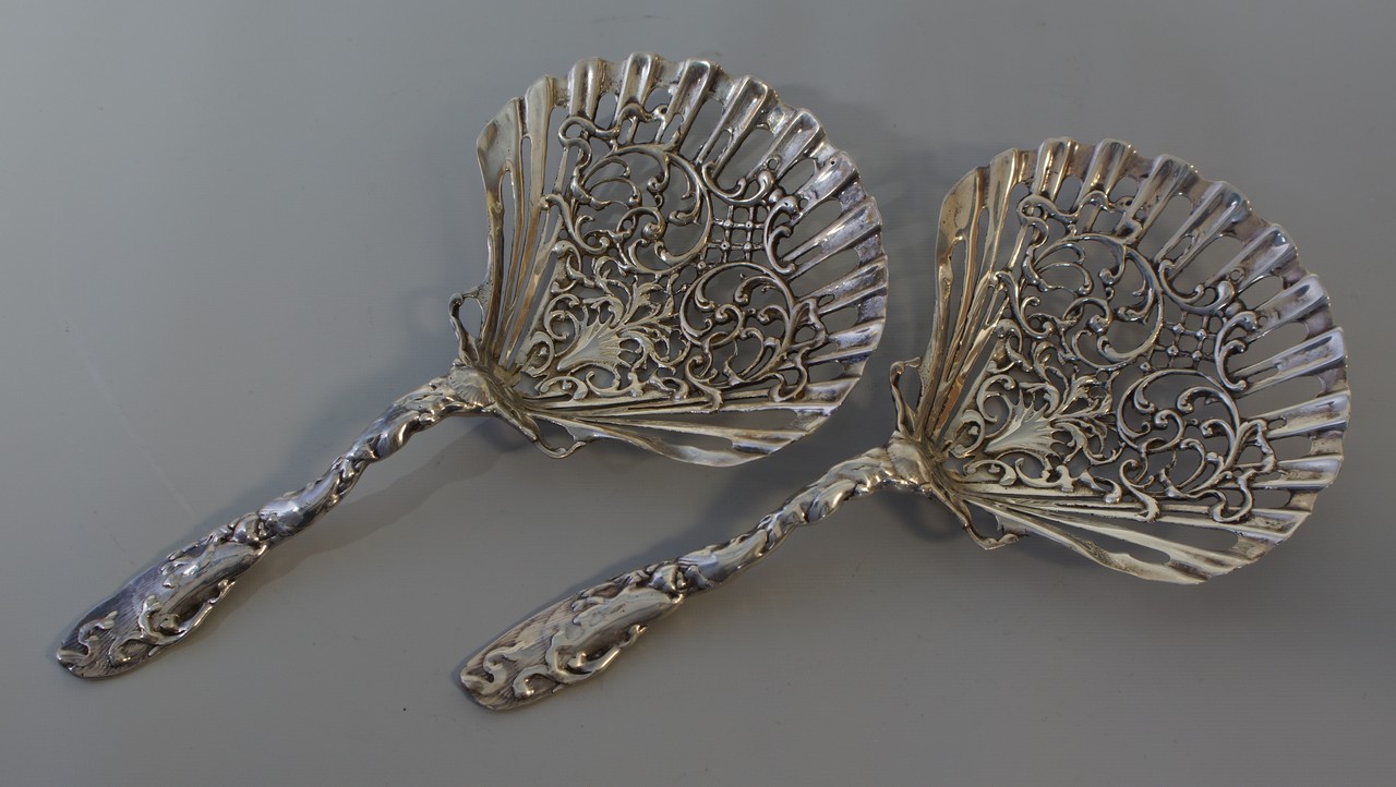 Appraisal: Pr ornate sterling silver pierced shell form serving spoons long