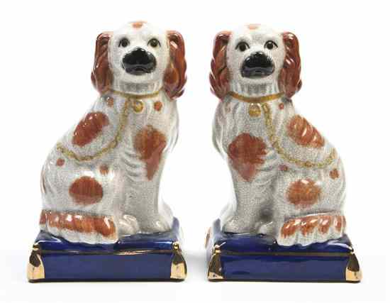 Appraisal: A Pair of Staffordshire Spaniels each seated on a pillow