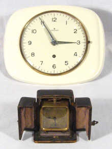 Appraisal: A small square brass travelling alarm clock in original case