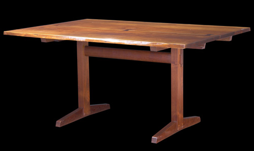 Appraisal: GEORGE NAKASHIMA Walnut trestle-base extension dining table with two leaves